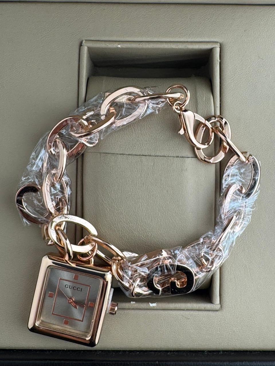 Guci jewelry watch designed in a "charm bracelet"
