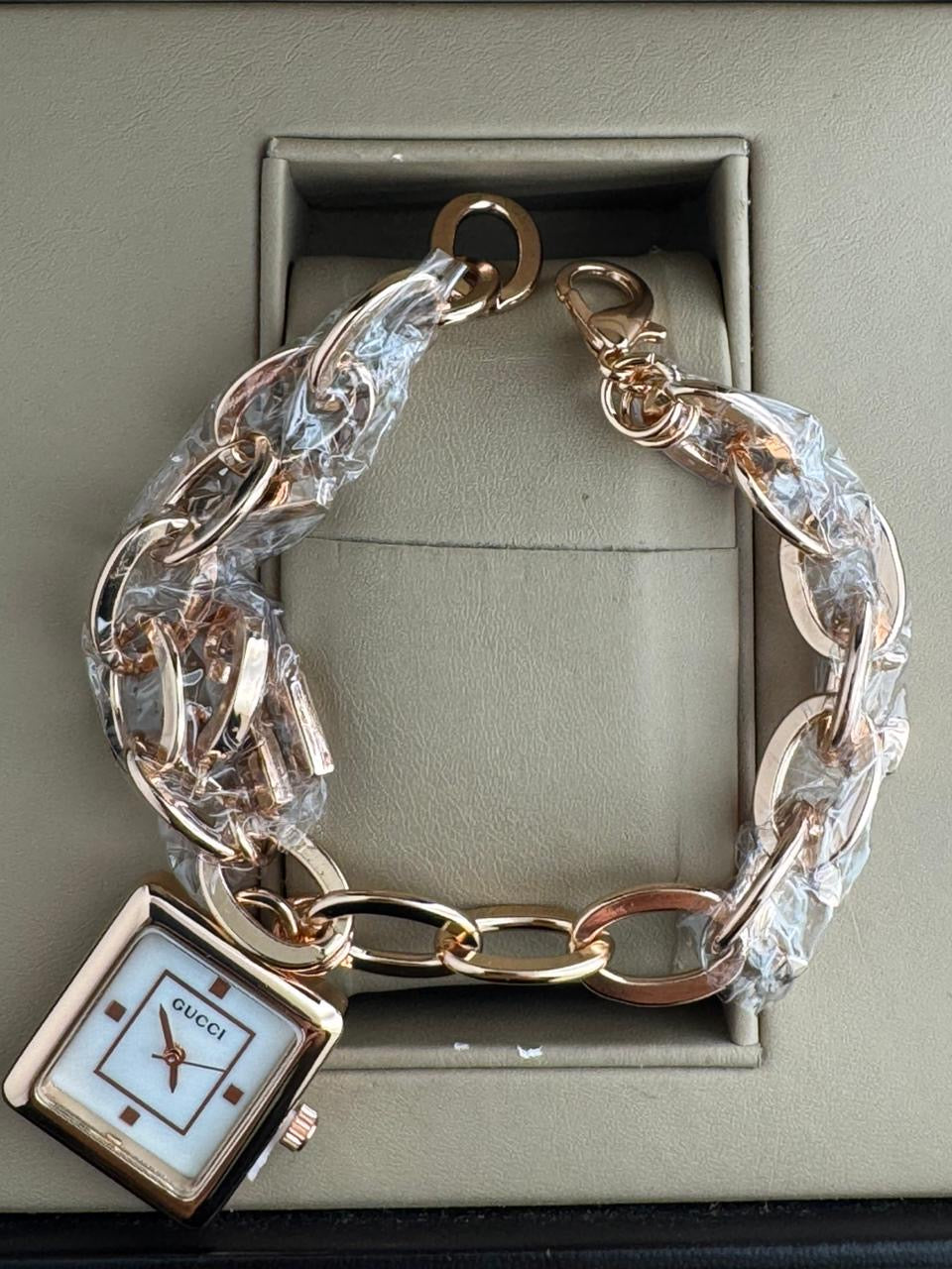 Guci jewelry watch designed in a "charm bracelet"